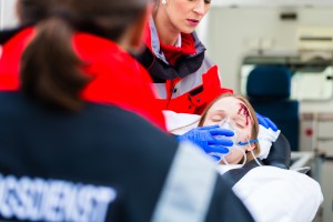 Ambulance helping injured woman on stretcher